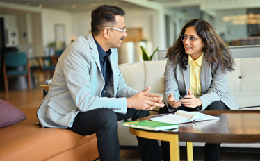 Administration professionals discussing talent strategy at work