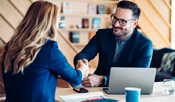 Executive business professionals meeting and shaking hands