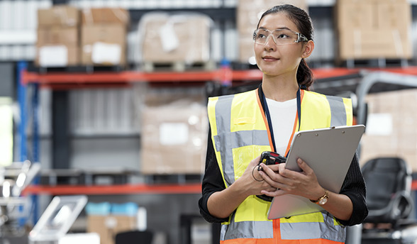  Female frontline worker holding clipboard in warehouse