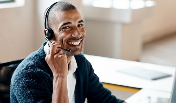 Expert support representative smiling holding headset