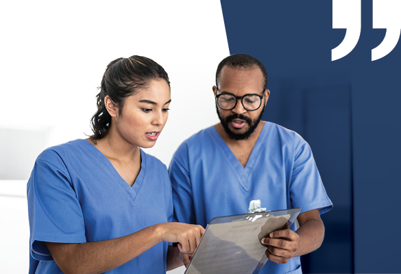 Two lab technicians looking at a patitient's report
